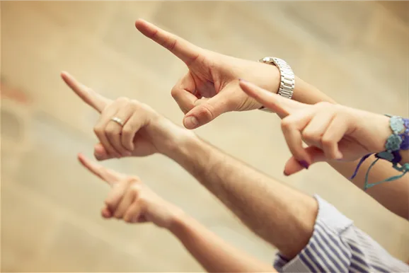 Hands pointing toward the Free For Charity donation form